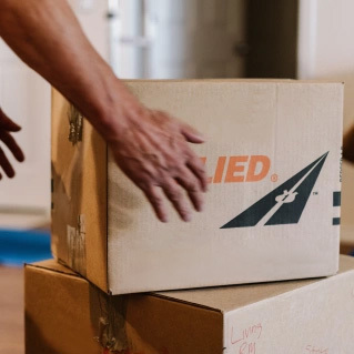 Picking up an Allied cardboard moving box